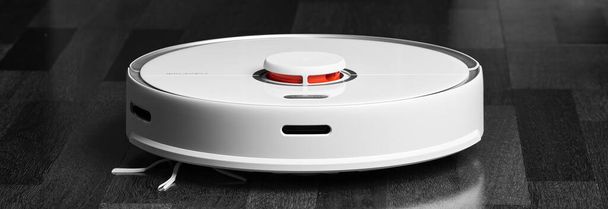 Smart Robot Vacuum Cleaner Xiaomi roborock s5 max on wood floor. Robot vacuum cleaner performs automatic cleaning of the apartment. 04.12.2020, Rostov region, Russia - 写真・画像