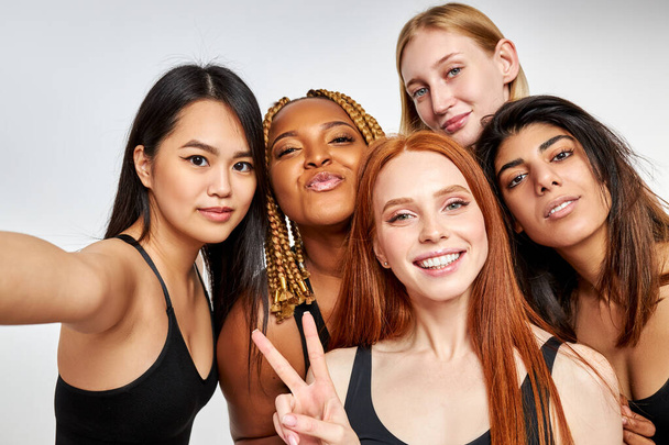 mixed race group of women models posing at camera - Fotó, kép