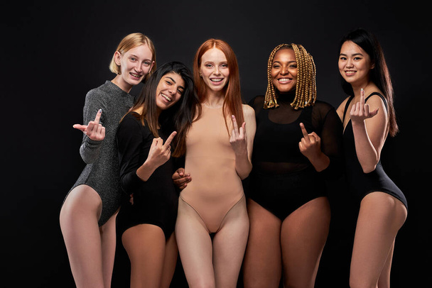 crazy diverse women show fuck gesture at camera - Fotó, kép