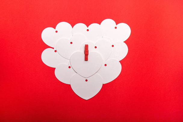 Um coração feito por cartões em forma de coração em branco sobre um fundo vermelho. Quando você tem tanto para escrever para o seu amor e um cartão simples não é suficiente. Para o dia dos namorados e ocasião especial. - Foto, Imagem