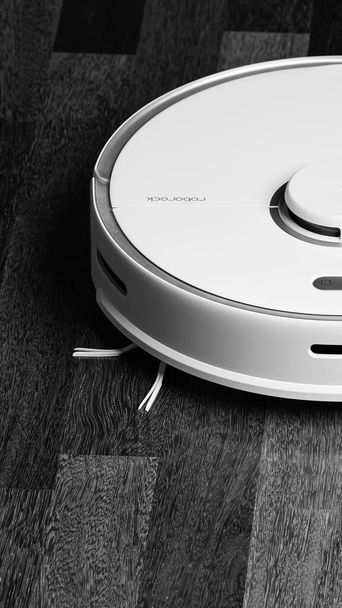 Smart Robot Vacuum Cleaner Xiaomi roborock s5 max on wood floor. Robot vacuum cleaner performs automatic cleaning of the apartment. 04.12.2020, Rostov region, Russia - Foto, imagen