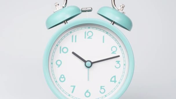 Green clock from 10:00 a.m. - 11:00 a.m., 1 hour time.It is a vintage table clock in green color. It has a plain white background. - Video