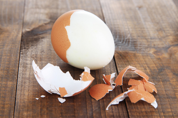 Peeled boiled egg on wooden background - Photo, image
