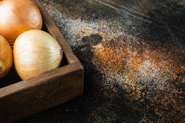 Fresh onions, on old dark rustic background with copy space for text - Photo, Image