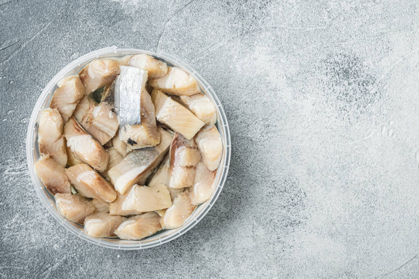 Sliced herring in oil marinated, on gray background, top view flat lay with copy space for text - Fotoğraf, Görsel