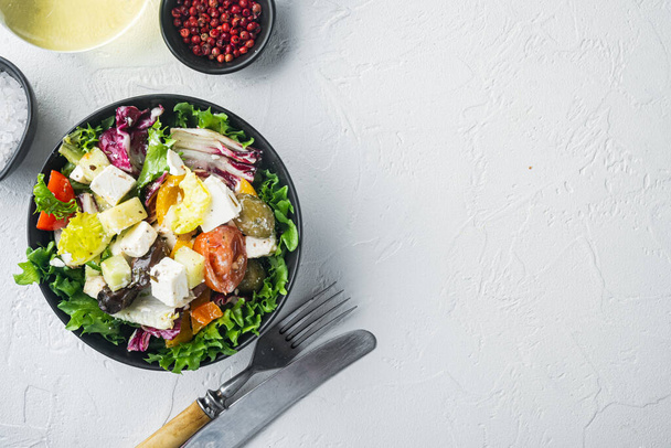Görög saláta paradicsompaprikával, olívabogyóval és feta sajttal, fehér alapon, felülnézeti lapos, másolt szöveggel - Fotó, kép