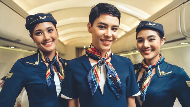 Group of cabin crew or air hostess in airplane - Photo, Image