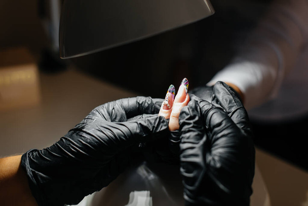 A young girl gets a close-up manicure on her hands in a beauty salon. Beauty salon - Fotografie, Obrázek