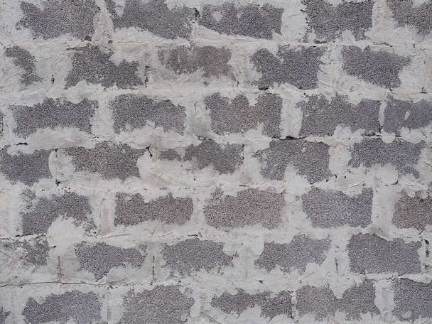 Muur met metselwerk van grijs schuim blok met naden dik besmeurd met cement. Textupe niet naadloos. Close-up foto - Foto, afbeelding