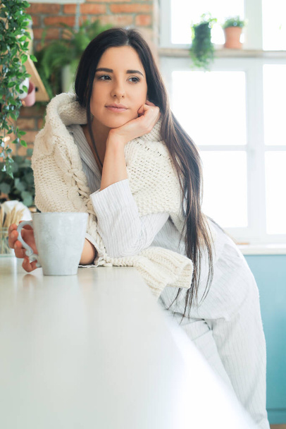 Woman in white sweater at home - Foto, immagini