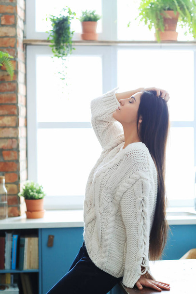 Woman in white sweater at home - Photo, Image