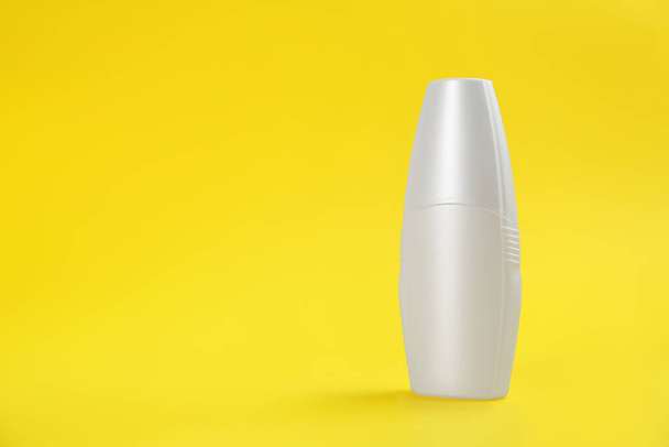Bottle with insect repellent spray on yellow background, space for text - Valokuva, kuva