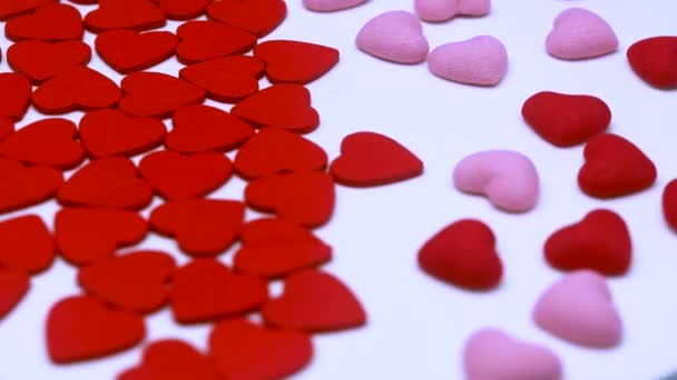 A lot of small multi-colored hearts rotates on a white background. Valentine's day concept. - Footage, Video