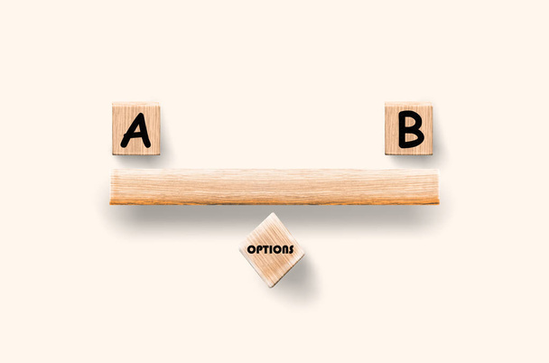 ptions A and B. Creative balance concept made by wood blocks, isolated on white background - 写真・画像