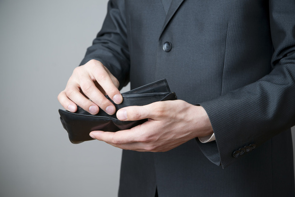 Businessman with empty purse in hands - Фото, зображення