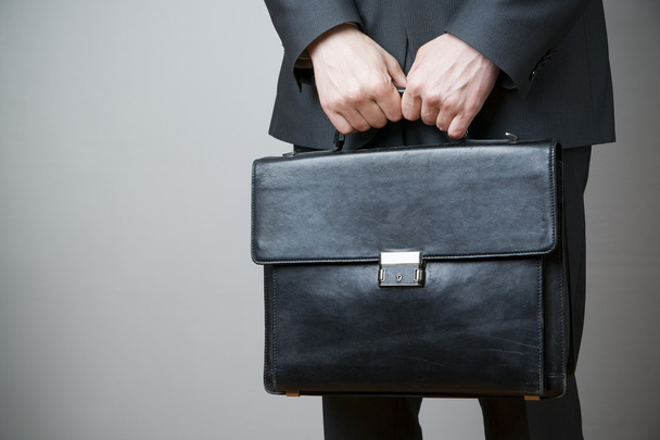 Businessman with briefcase in hand - 写真・画像