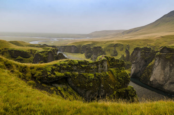 View of the cliffs and a river from above, Fjadrargljufur Canyon, Kirkjubaejarklaustur, Iceland - Foto, Bild