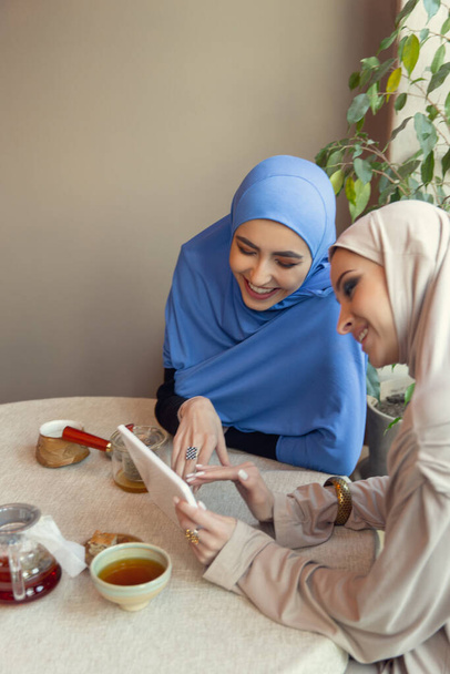 Beautiful arab women meeting at cafe or restaurant, friends or business meeting - Φωτογραφία, εικόνα