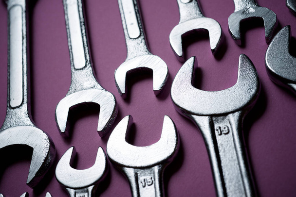 Wrenches on a purple table. - Фото, зображення