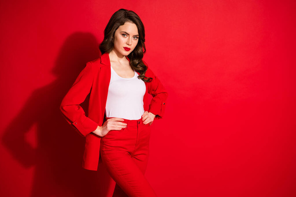 Photo of pretty stunning lovely shiny girl put hands on waist isolated over bright red color background - Foto, afbeelding
