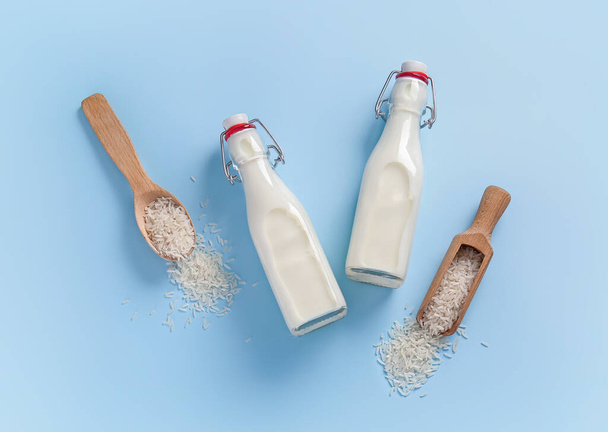 Bottles of rice milk on color background - Photo, Image