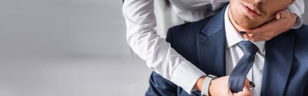 cropped view of secretary touching face of businessman while seducing him in office, banner - Photo, Image