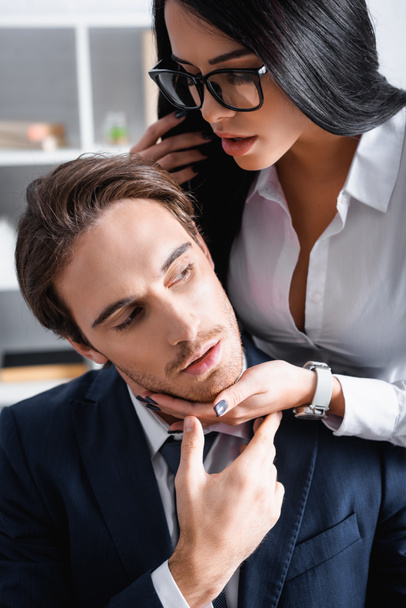 passionate brunette businesswoman seducing young colleague in office - Photo, Image