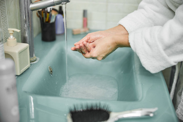 Female washing hands with foam at home - Photo, image