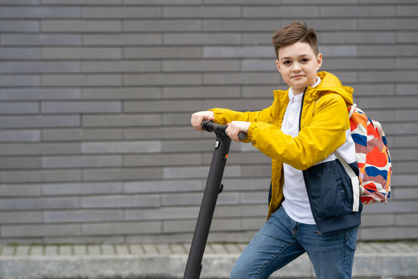 Modern teenager on electric scooter. Ecological transport concept  - Photo, Image