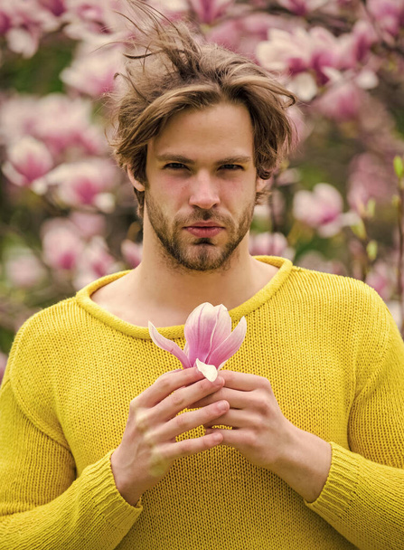 You are so beautiful. spring holiday. Mothers day gift. sakura smell. enjoy good weather. allergy. sexy guy blooming magnolia flower tree. man natural seasonal background. feel refreshed. Womens day - Foto, immagini