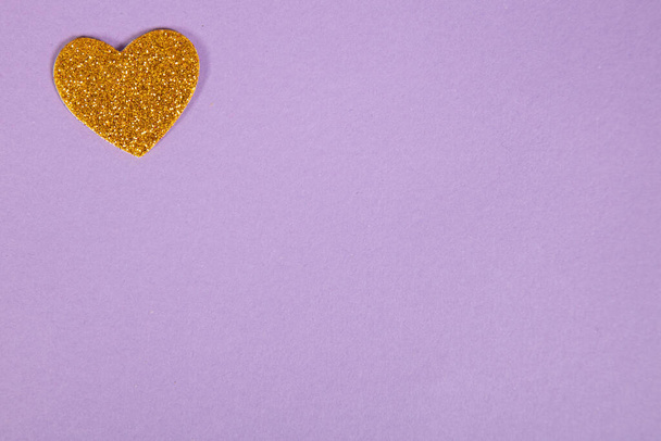 beautiful yellow heart on purple background, love concept, top view - Foto, Imagem