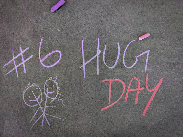 Il testo dell'iscrizione sulla lavagna grigia, # 6 Giorno dell'abbraccio con coppia di abbracci disegnati a mano. Utilizzando pezzi di gesso colore. Settimana di San Valentino - Foto, immagini