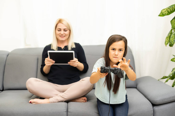 happy family together. mother and her child girl playing video games. family relax. - Photo, Image