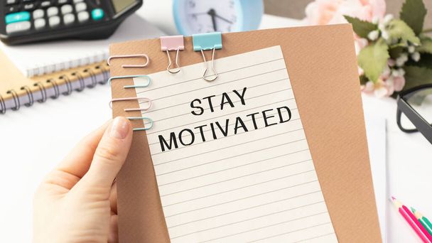 Text Stay motivated on white paper, business concept - Photo, Image