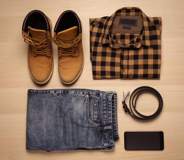 Flat lay composition with stylish clothes and accessories on wooden background - Photo, Image