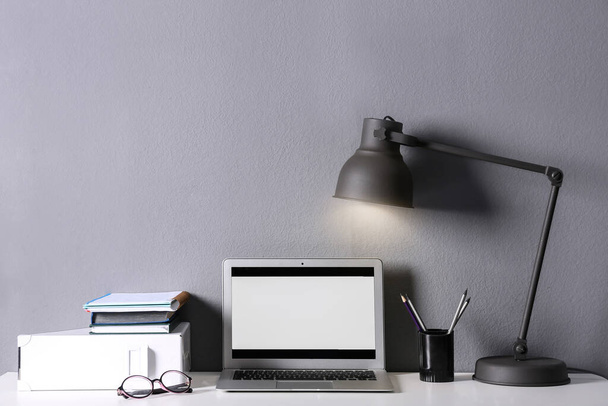 Modern laptop and stationery on table in office. Space for text - Foto, Imagem