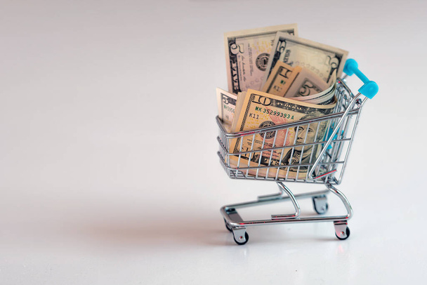 shopping cart full of dollar bills , business, finance, economy concept - 写真・画像