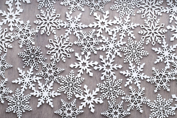 White Wooden Decorative Snowflakes on wooden Background, the Christmas Decor. - Foto, immagini