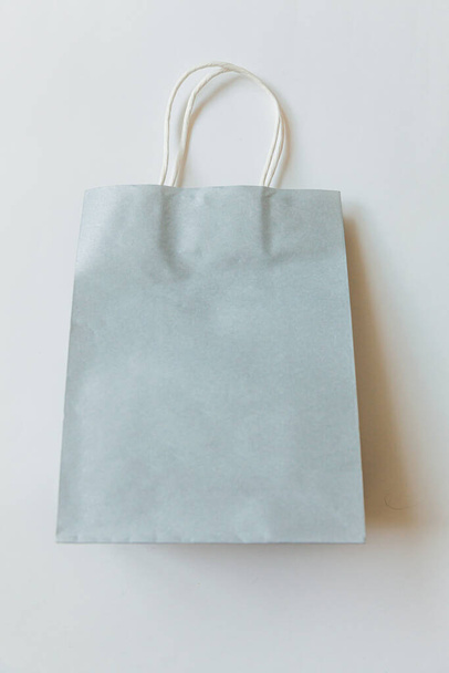 Simply minimal design shopping bag isolated on white background. Online or mall shopping shopaholic concept. Black friday Christmas season sale. Flat lay top view copy space mock up - Photo, Image