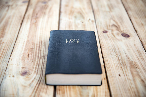 Holy Bible on the wooden table backgroun - Foto, Imagen