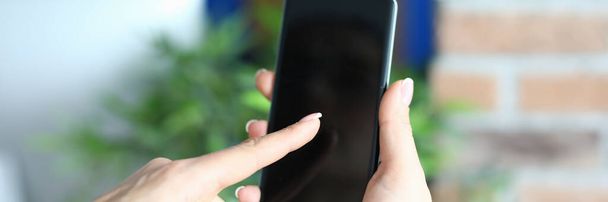 Hands holding smartphone in office close up - Фото, изображение