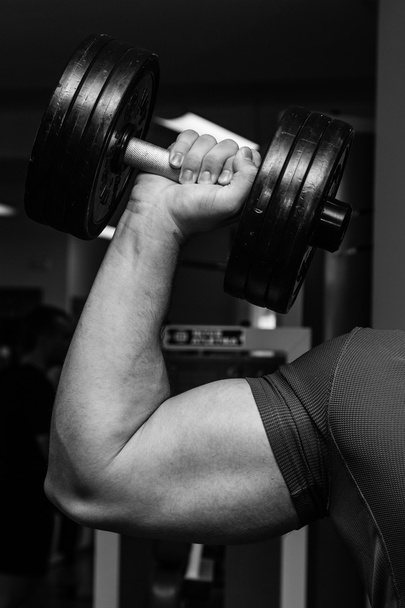 Man doing exercises with dumbbell - Photo, Image