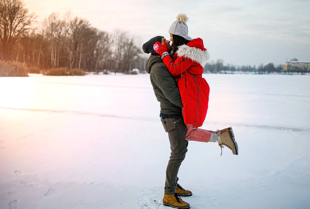 Χαρούμενο πολυεθνικό ζευγάρι που παίζει στο χιόνι - Φωτογραφία, εικόνα