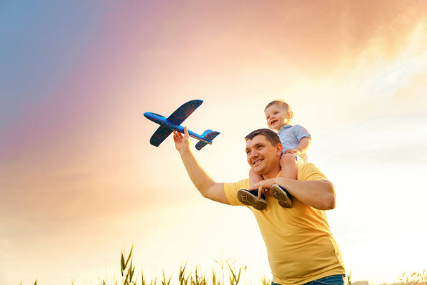 happy father with son playing with toy plane. dream to be a pilot - Zdjęcie, obraz