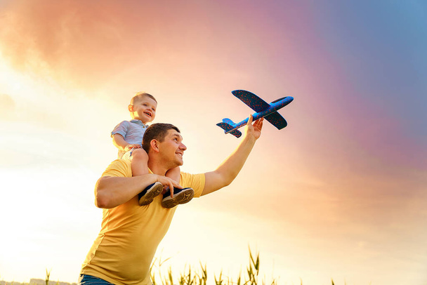 happy father with son playing with toy plane. dream to be a pilot - Fotó, kép