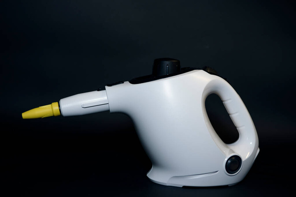 Household steam cleaner close-up. The device produces steam for disinfection from germs, dirt, viruses and insects. Home cleaning concept. - Photo, Image