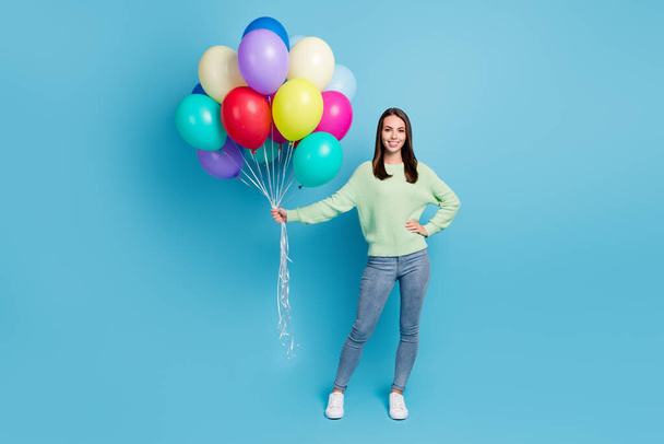 Full length body size photo of nice friendly girl celebrating holiday with balloons smiling isolated on bright blue color background - Foto, immagini