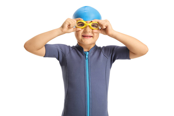 Boy in a wetsuit putting on swimming goggles isolated on white background - Zdjęcie, obraz