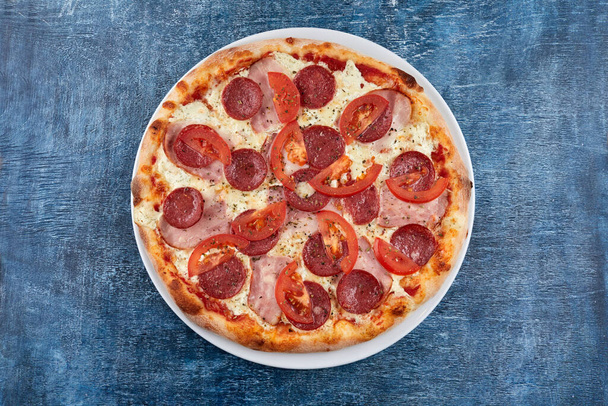 hete smakelijke Italiaanse pizza op witte plaat - Foto, afbeelding