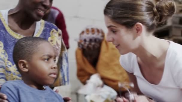 Medical worker from charity organisation lets little boy use her stethoscope - Filmagem, Vídeo